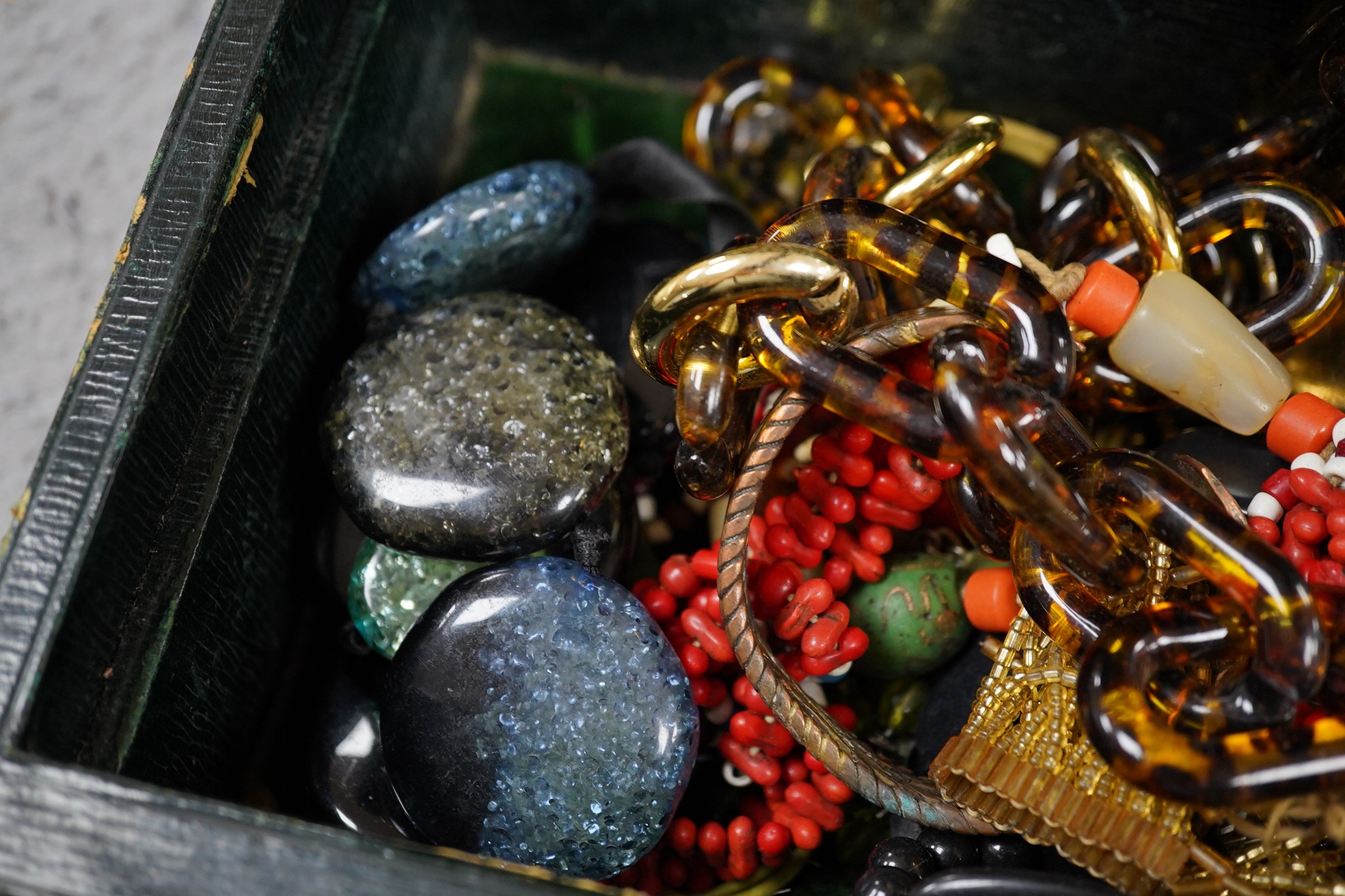 A quantity of assorted mainly costume jewellery in two boxes, including a coral bead necklace. Condition - poor to fair